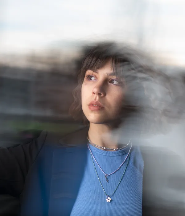 lost angels drug detox woman blue sweater looks out window