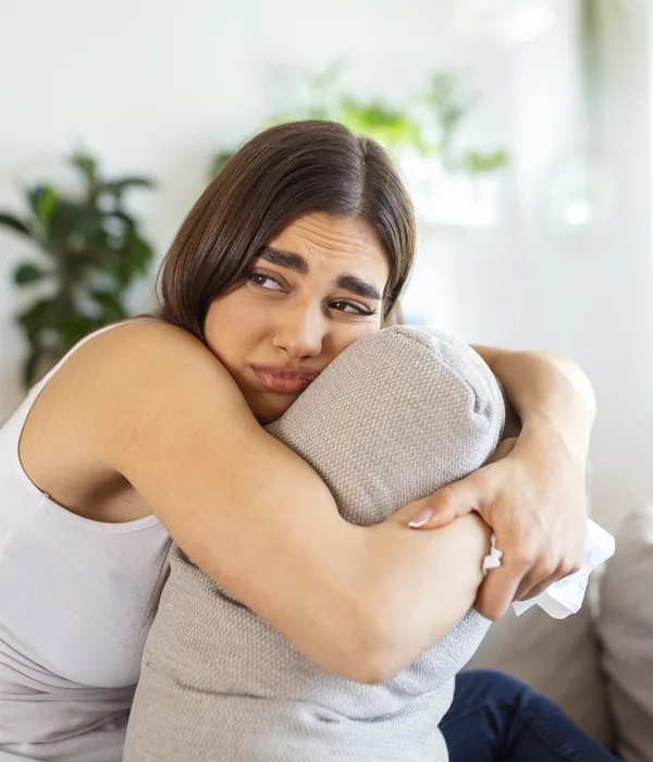 lost angels drug detox woman sitting couch arm around neck