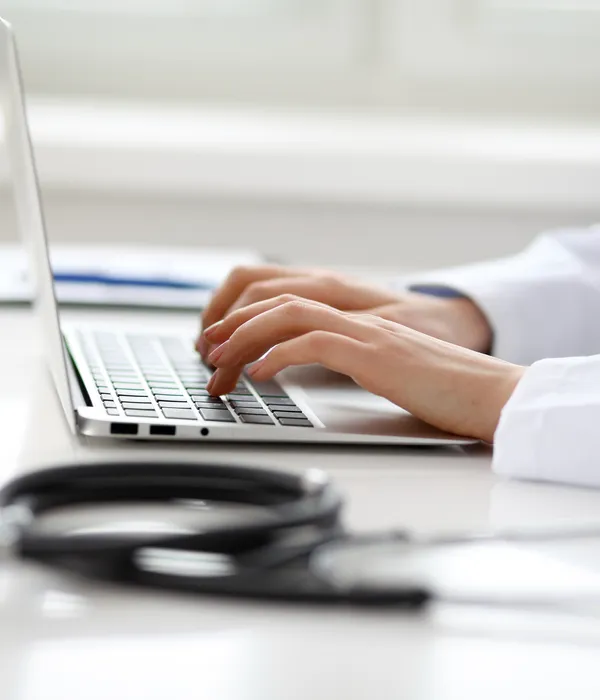 lost angels drug detox woman typing laptop