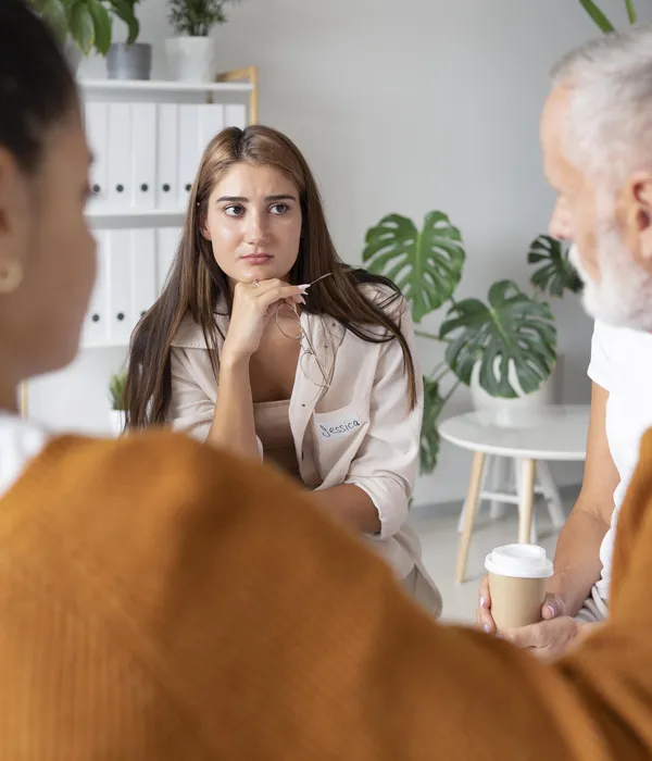 lost angels group therapy woman sitting front mirror face hands