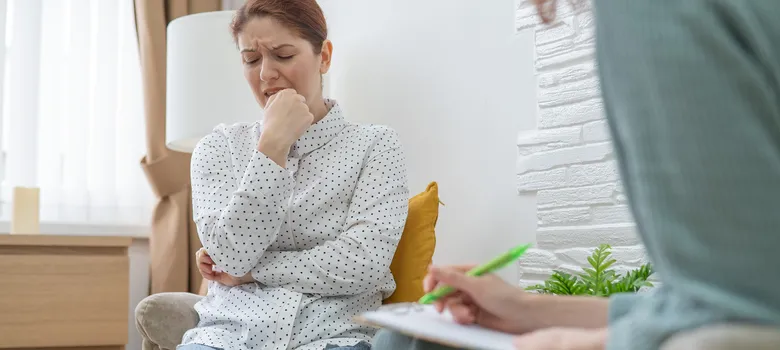 lost angels therapy woman sitting couch hand chin