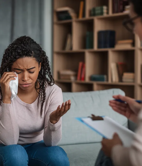 lost angels therapy woman sitting couch hand nose another